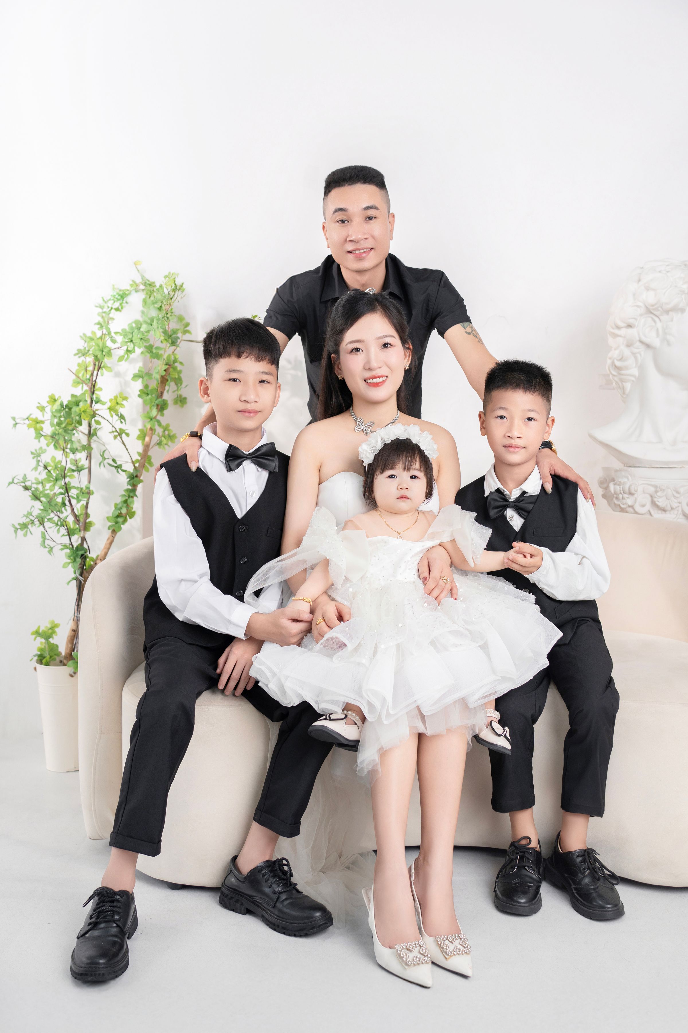 Formal family portrait with five people