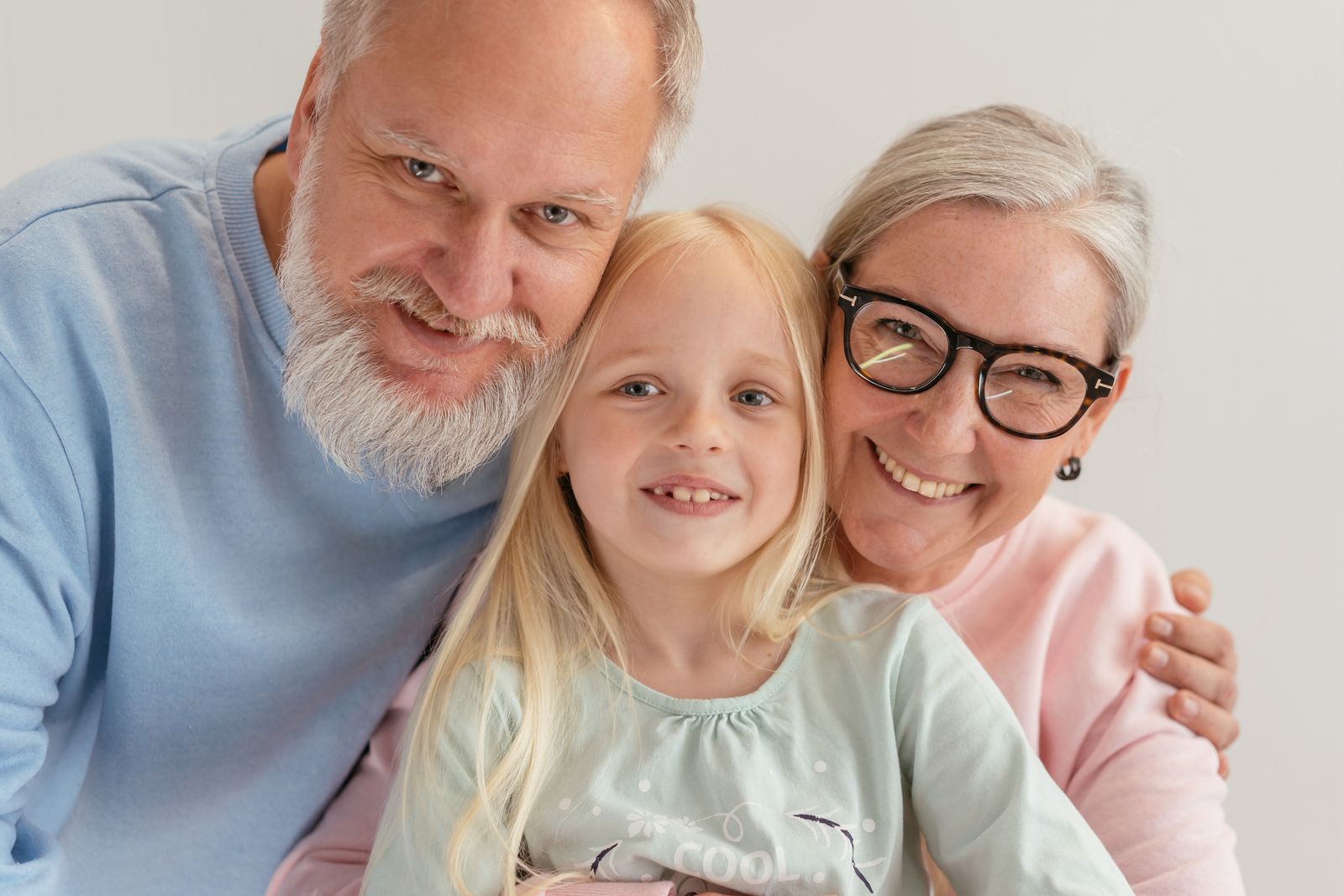 Original photo: grandparents smiling with their granddaughter at home
